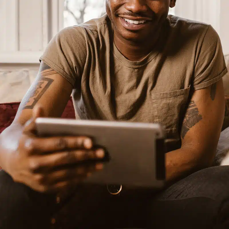 black man having making a video call on ipad, smiling, Long-distance relationships, Therapy, Fort Lauderdale, FL